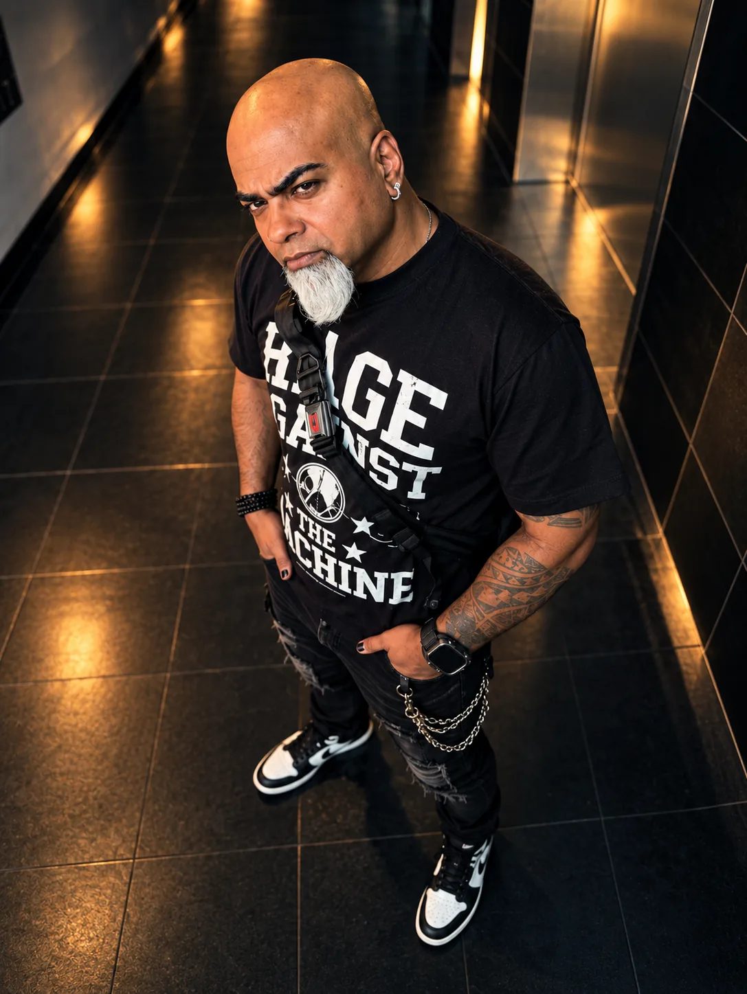 DJ Victor Shaqur standing in a dark corridor with warm stage-like lighting